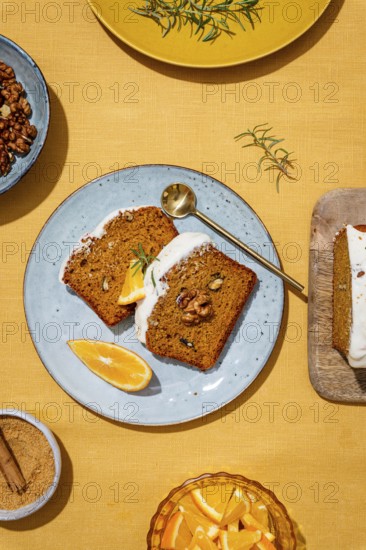 Slices of carrot cake loaf topped with rich cream cheese frosting and garnished with walnuts and