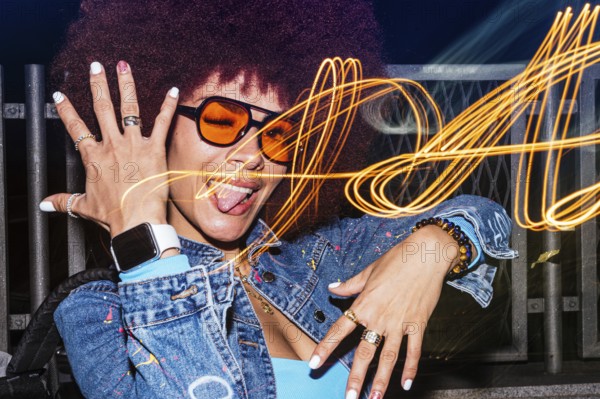 African descendant woman with afro hair showcases her playful side, winking and sticking her tongue