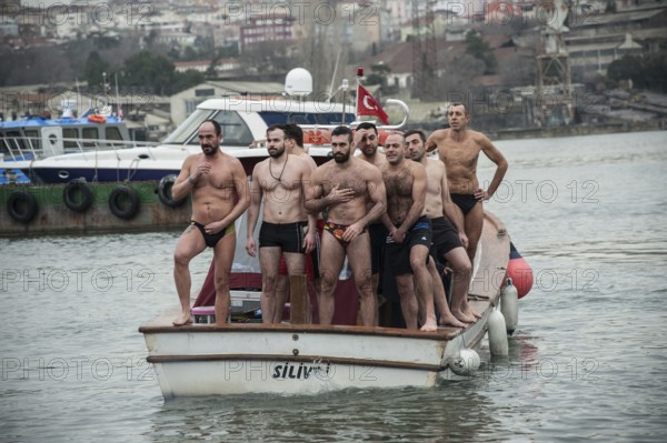 Istanbul, Turkey, January 6th 2017 Swimmers cross themselves and prepare to dive into the Golden