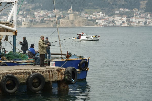 Canakkale, Turkey. 18th February 2022 Turkish fishermen on the pier overlooking the Dardanelles