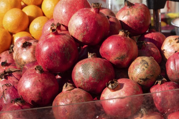 Brightly colored Pomegranates are juicy, sweet fruits with edible seeds called arils inside. A