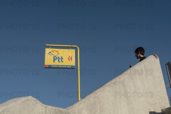 Istanbul, Turkey. October 3rd 2021 Bright Yellow PTT sign, the Turkish Post Office against a deep