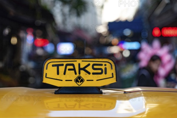 Istanbul, Turkey. November 10th 2022 An illuminated yellow Turkish taxi sign on a car parked in the
