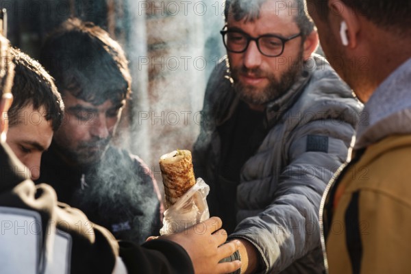 Istanbul, Turkey. November 14th 2023 A customer buying a fish wrap sandwich known as Balik Ekemek