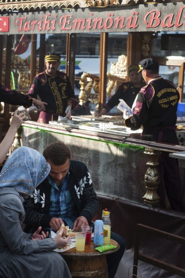 Istanbul, Turkey. April 12th 2016 A Turkish couple eating a fish sandwich the famous street food