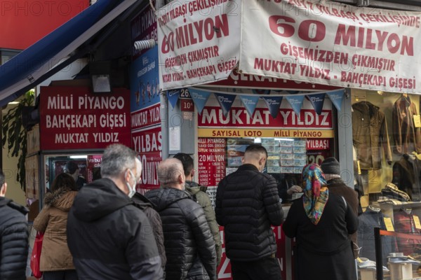 Istanbul, Turkey. December 27th 2021 Turkish men and women queue to buy Milli Piyango tickets, the