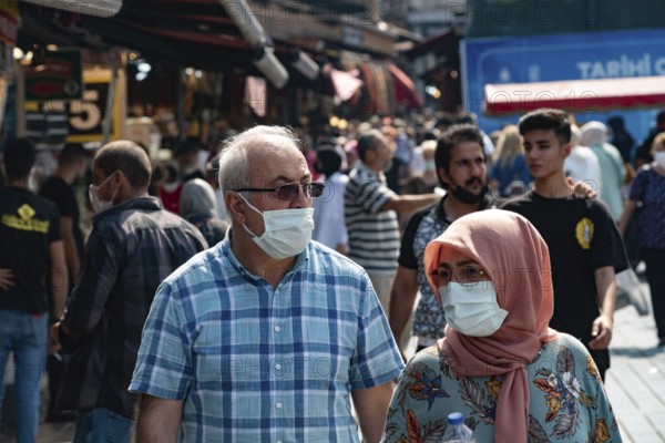 Istanbul, Turkey 25th August 2021 A Turkish couple wearing protective face masks in a busy market