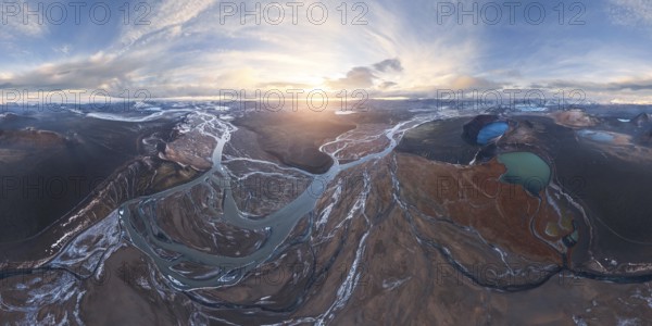 A breathtaking aerial view of Iceland's Highlands at sunrise, showcasing meandering rivers,