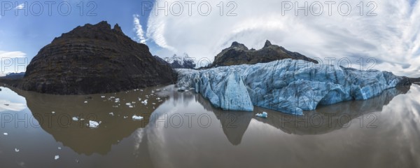 Panoramic view of Vatnajokull National Park's stunning ice formations, rugged mountains, and serene