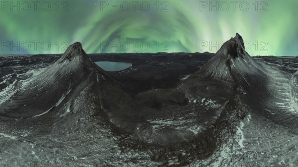 A breathtaking panorama of the Northern Lights dancing over two snow-dusted peaks in the Icelandic