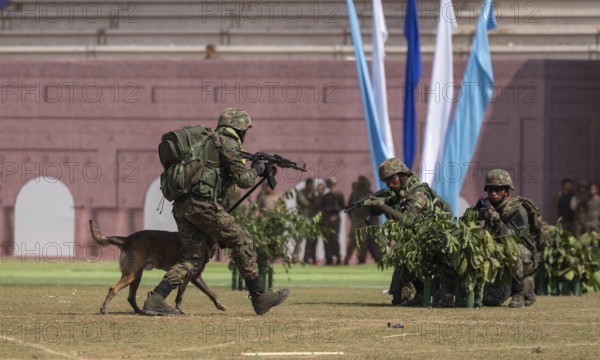 A sniffer dog accompanies personnel of the Central Reserve Police Force during a simulated