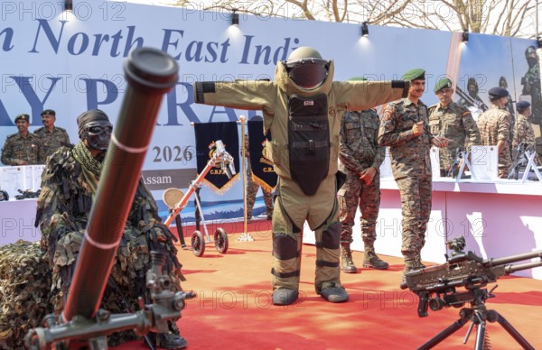 CRPF personnel display a bomb disposal suit and various weapons during a public exhibition at the