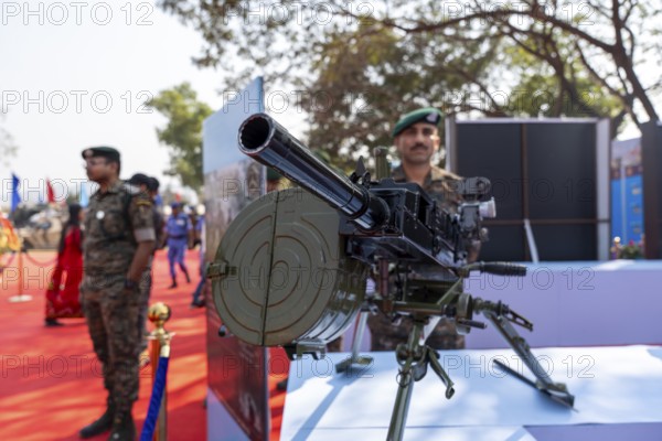 A heavy machine gun mounted on a tripod is displayed during a weapon exhibition by the Central