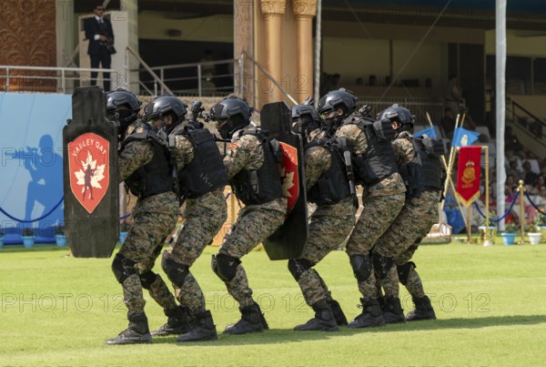 Personnel of the Valley QAT unit of the Central Reserve Police Force advance in shield formation