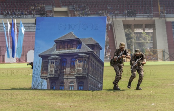 Personnel of the Central Reserve Police Force simulate an urban counter-terror operation, as they
