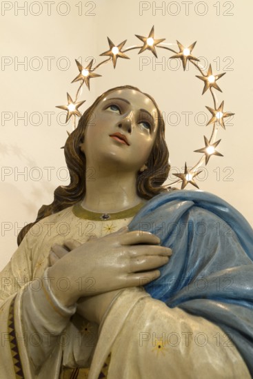 Wooden bust of St. Mary illuminated with a wreath of stars, Venice, Italy