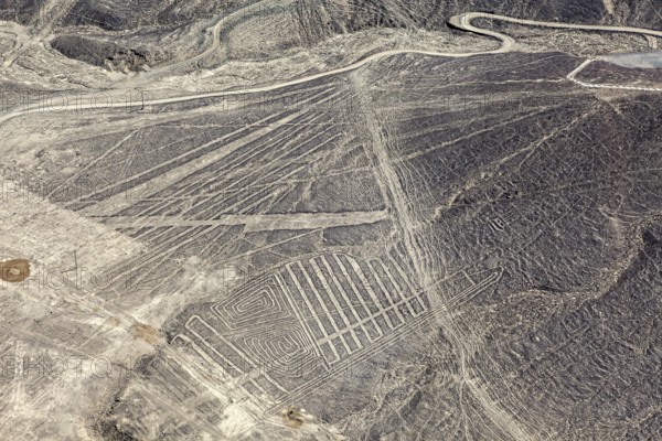Aerial view of a desert region with numerous Nazca line patterns in Peru, the geoglyphs and images