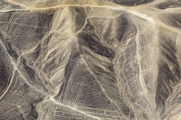 Aerial view of geoglyphs in the rugged Nazca desert with distinctive lines, the geoglyphs and