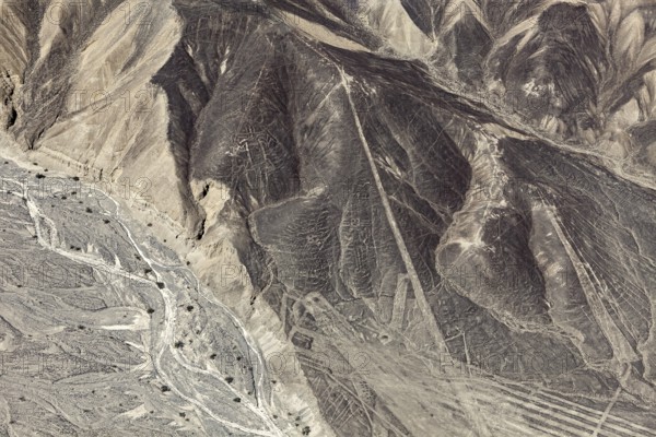 A mountainous country with a recognizable line pattern flying over the desert, the geoglyphs and