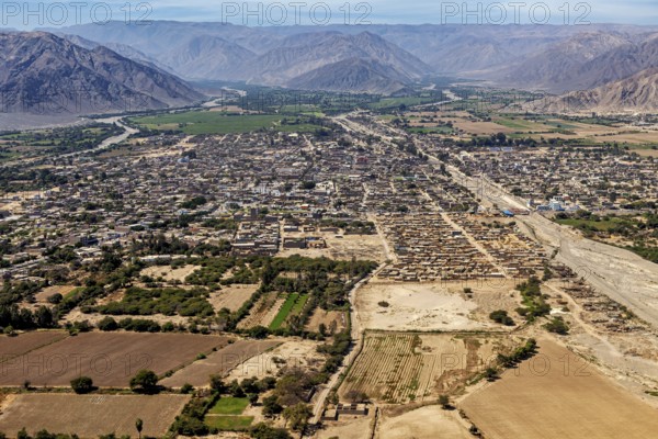 City seen from the air with surrounding fields and mountains in the background, clear panorama, The
