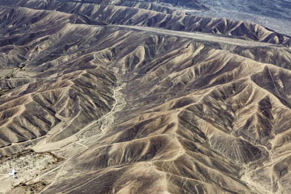 Barren range of hills with erosion-shaped structures in a dry environment, the desert landscape