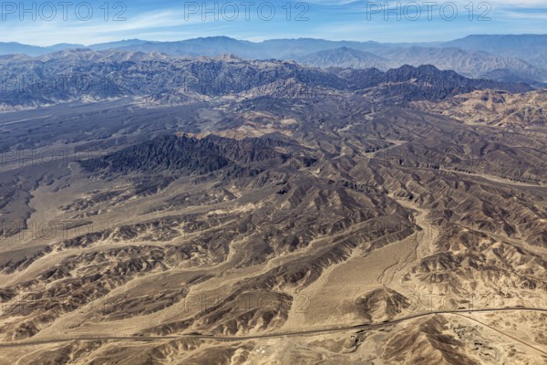 Barren mountainous desert area with characteristic hills, taken from above, The desert landscape