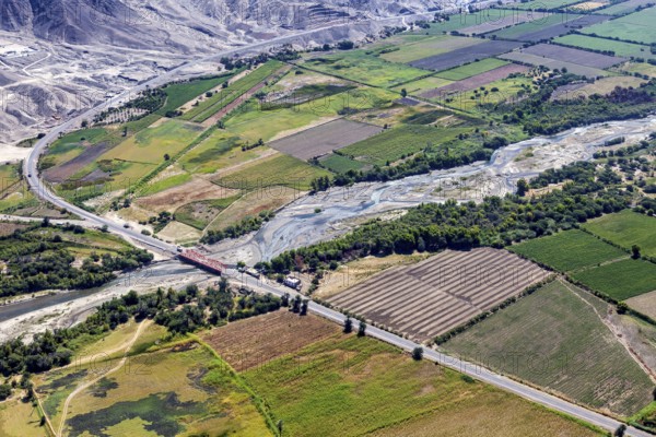 Picturesque green landscape with a river and a wooded road in the valley, The desert landscape near