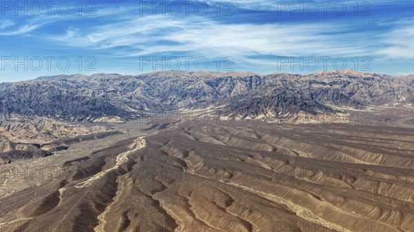 Landscape with dry desert area and mountain chain under blue sky, The desert landscape near Nasca