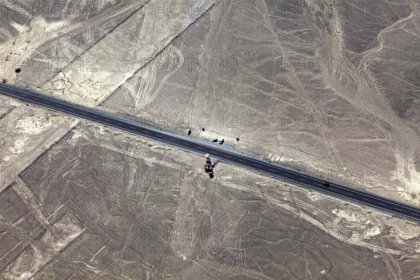 Road through a desert with ancient lines and shapes in the area, the geoglyphs and paintings in the