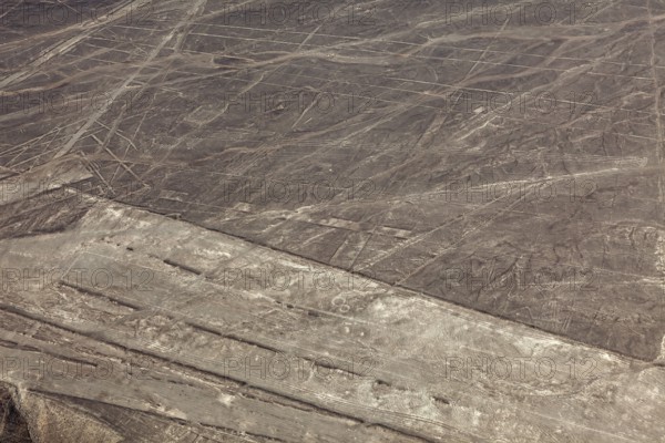 Nazca lines visible from the air with geometric shapes on barren desert soil, the geoglyphs and