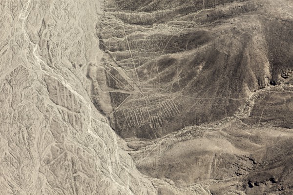 Impressive lines and shapes stretch across the barren mountain flank, the geoglyphs and paintings