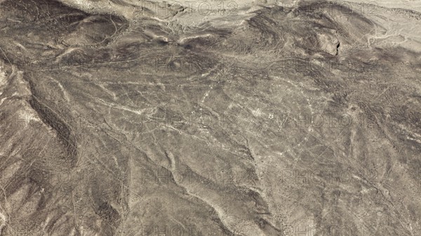 View of a dry desert area with recognizable ancient lines, geoglyphs and images in the desert near