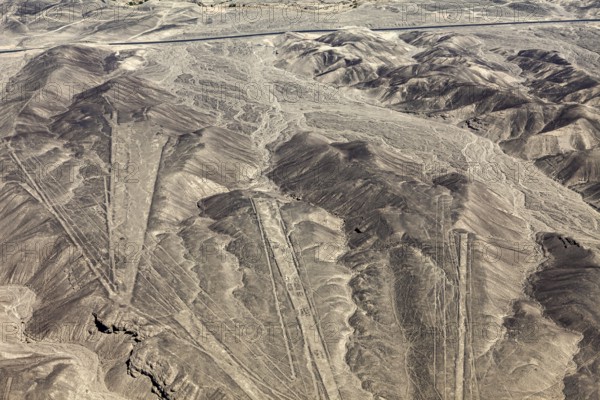 Extensive view of a desert region with geometric patterns in the mountains, the geoglyphs and