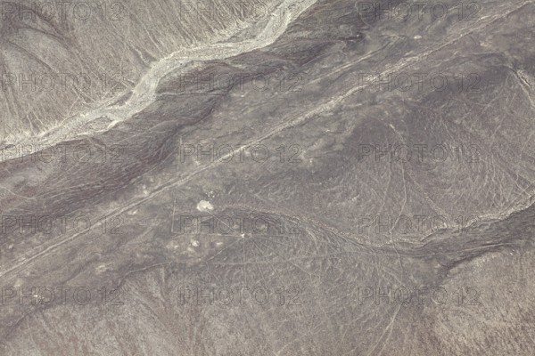 Dry, sandy landscape with distinctive lines and patterns, the geoglyphs and drawings in the desert