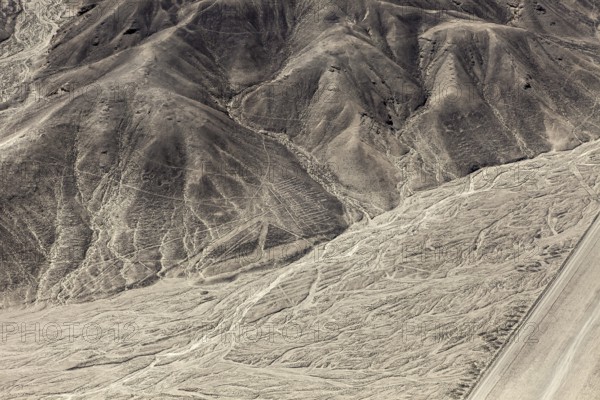 Hilly landscape with incised lines and patterns in the desert, the geoglyphs and drawings in the