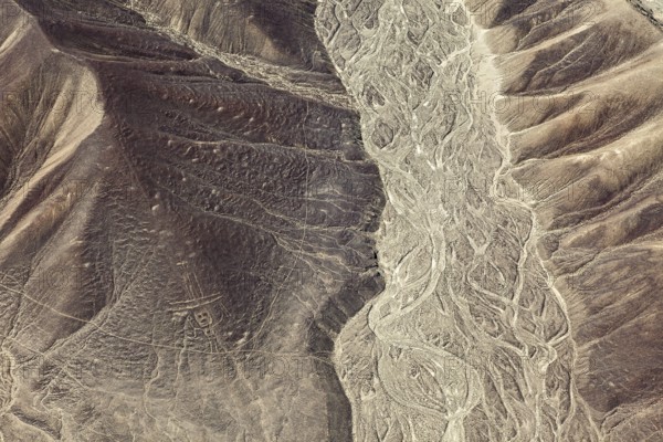 Aerial view of a hilly desert landscape with old patterns, geoglyphs and paintings in the desert