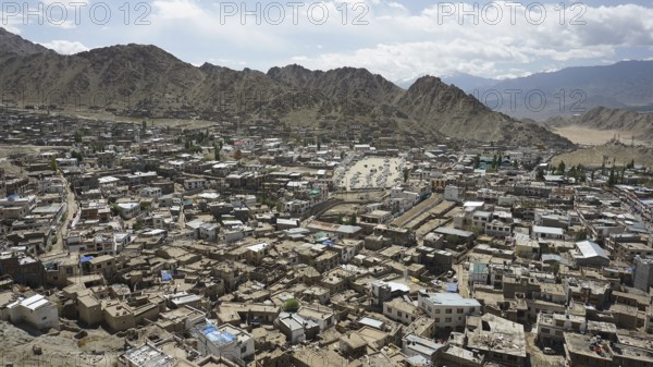 City view from Leh Palace over Leh with mountains and cloudy sky, Ladakh, North India, Himalayas,