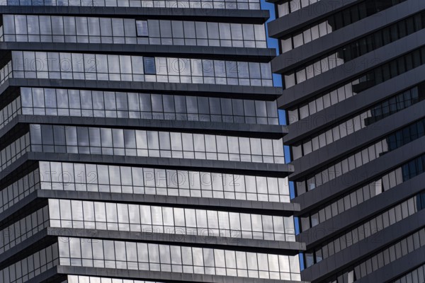 A detailed look at a modern skyscraper featuring geometric patterns formed by windows and