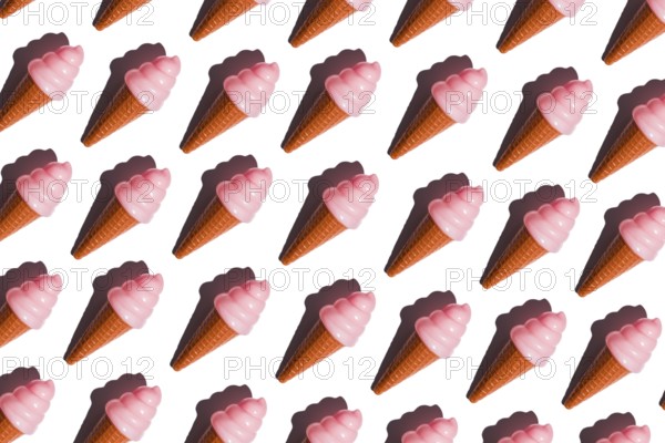 Pink plastic ice cream cones arranged in a pattern represent the critique of junk food and plastic