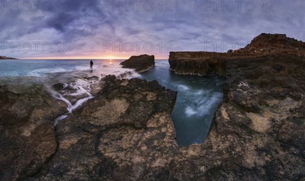 Captivating sunrise over rocky shoreline at Cabo Cervera in Torrevieja, Alicante, Spain A lone