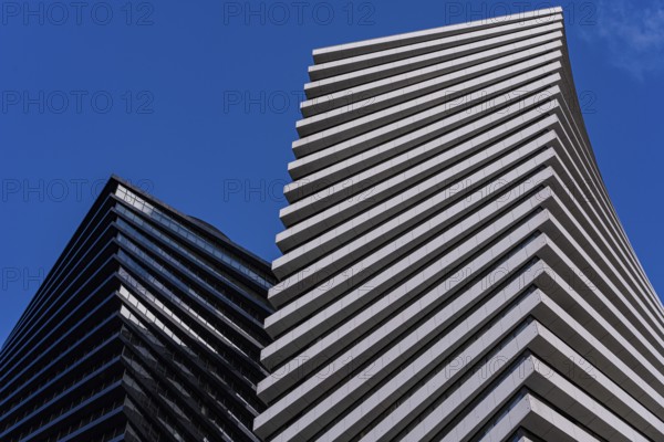 From below striking image of modern architecture showcasing geometric patterns and contrasting
