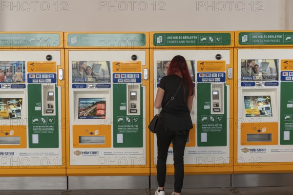 Budapest, Hungary. October 1st 2023 A woman buying a train ticket from an automatic machine at