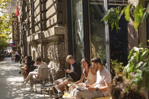 Bucharest, Romania. October 29th 2023. Young people relax outside a popular cafe in Grand Old Town
