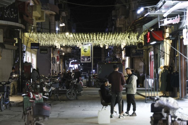 Syrians shop at the historic Al-Hamidiyah Bazaar adjacent to the Umayyad Mosque during the early