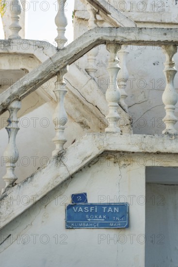 Bodrum, Mugla, Turkey. April 23rd 2022 Blue street sign for Vasfi Tan Sokak and traditional white