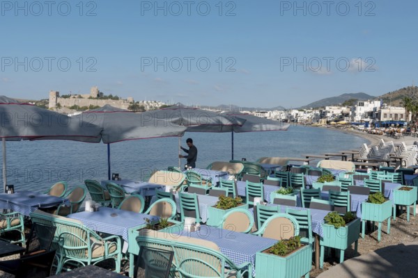 Bodrum, Mugla, Turkey. April 21st 2022 A waiter prepares tables on the beach side cafe in Bodrum