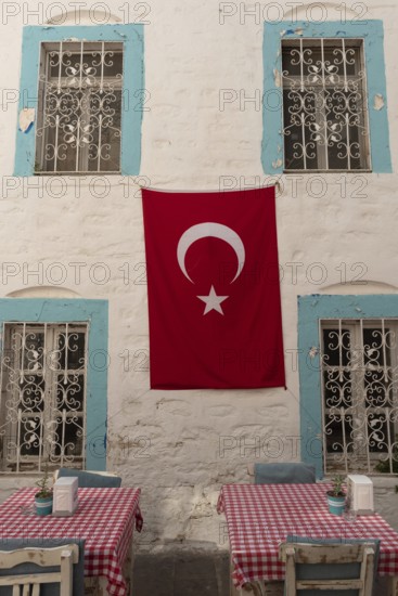 Bodrum, Mugla, Turkey. April 23rd 2022 Pretty cafe tables set against a beautiful pastel blue