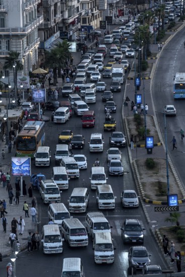 Busy traffic with lots of public mini buses along the Mediterranean Sea front of Alexandria, Second