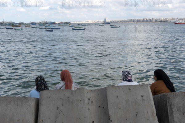 Alexandria, Egypt. December 2nd 2022 Egyptian Muslim Women sit on large concrete blocks designed to