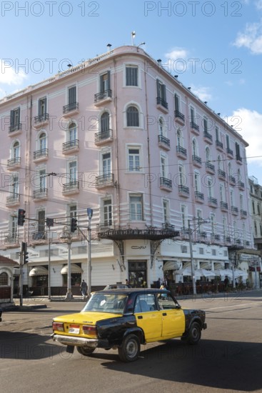 Alexandria, Egypt. December 4th 2022 Egyptian taxi passing the famous Trianon Cafe restaurant, Saad